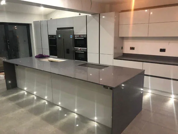 Grey gloss kitchen with a sparkle grey quartz island and spotlights set into the floor