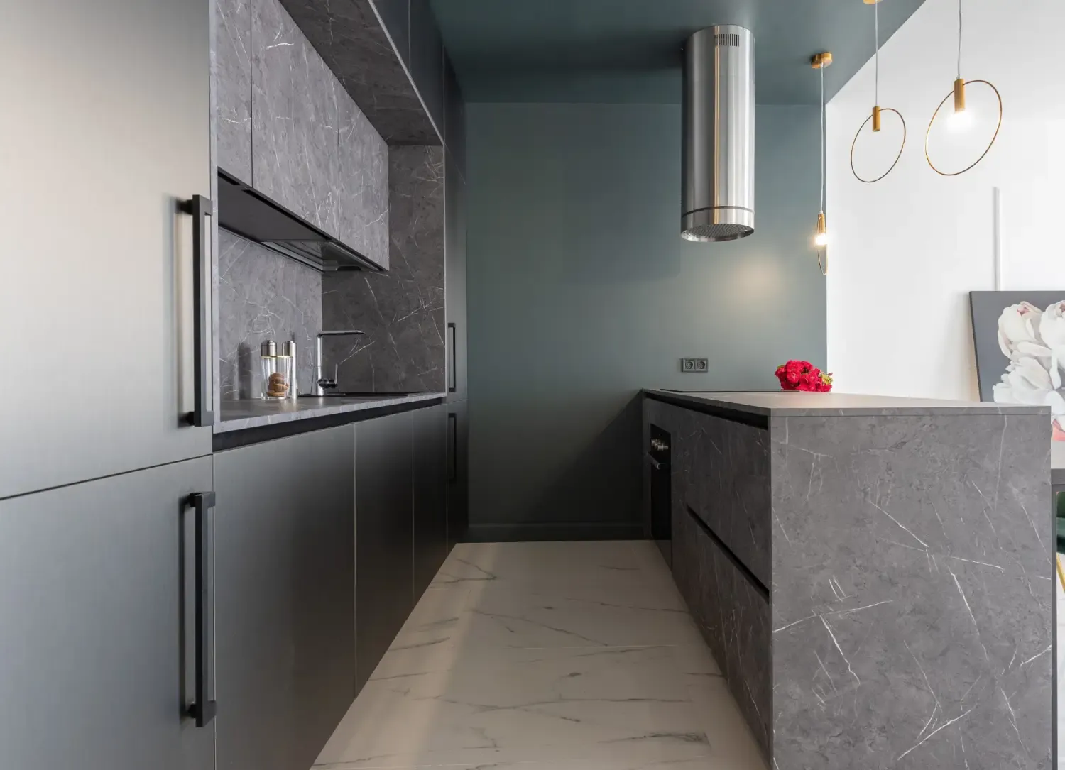 Matt charcoal galley kitchen with long black bar handles, grey marble-effect tall units and a marble-effect peninsula